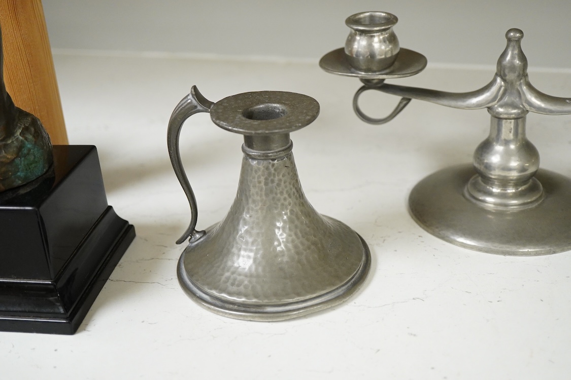 A Liberty Tudric pewter two branch candlestick, 22cm wide and two hammered candle holders.